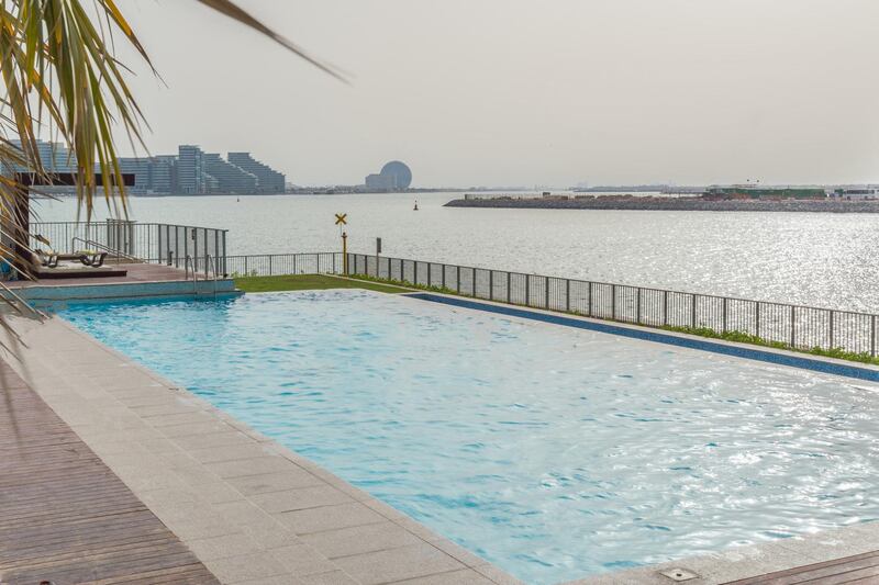The swimming pool and complex overlooks nearby Yas Island. Courtesy LuxuryProperty.com