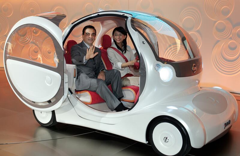 Mr Ghosn takes a ride in a Nissan Pivo concept car ahead of the Tokyo Motor Show in 2005. Reuters