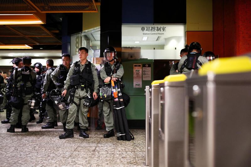 Police stand guard inside North Point station. Bloomberg