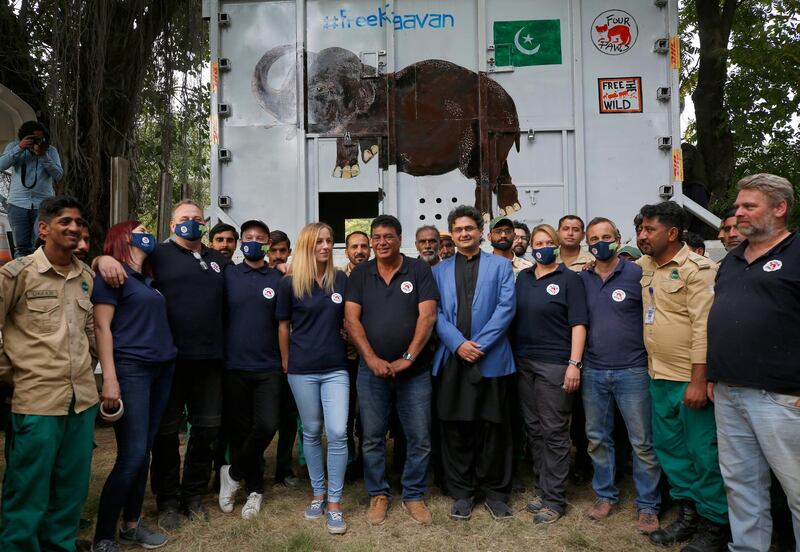 Pakistani wildlife workers, officials and experts from the international animal welfare organization Four Paws, pose for photograph next to a crate holding an elephant named Kaavan before he is transported to a sanctuary in Cambodia, at the Marghazar Zoo in Islamabad, Pakistan. AP