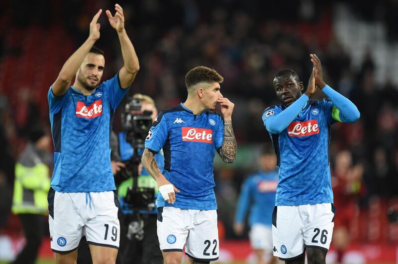 Napoli's Nikola Maksimovic (L),  Giovanni Di Lorenzo (C) and Kalidou Koulibaly applaud the fans at the end of the game. AFP