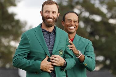 epaselect epa08822881 Dustin Johnson of the US (L) is presented his green jacket by defending champion Tiger Woods of the US (R) after Johnson won the 2020 Masters Tournament at the Augusta National Golf Club in Augusta, Georgia, USA, 15 November 2020. After being delayed seven months by the coronavirus pandemic, the 2020 Masters Tournament is being held without patrons 12 November through 15 November. EPA/ERIK S. LESSER