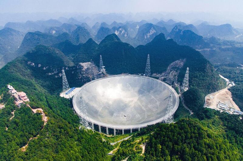 Aan aerial view shows the Five-hundred-meter Aperture Spherical Telescope (FAST) in the remote Pingtang county in south-west China's Guizhou province where China has begun operating the world's largest radio telescope to help search for extraterrestrial life. Liu Xu/Xinhua via AP
