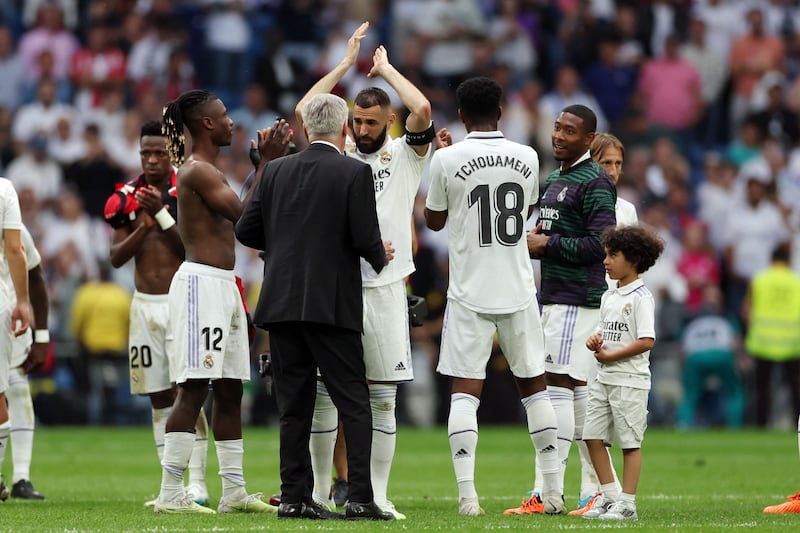 Real Madrid's French forward Karim Benzema applauds as he talks with Carlo Ancelotti. AFP