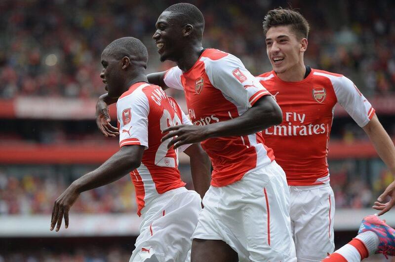 Joel Campbell, left, and Yaya Sanogo, right, celebrate with Hector Bellerin during their win over Benfica on Saturday. Michael Regan / Getty Images / August 2, 2014