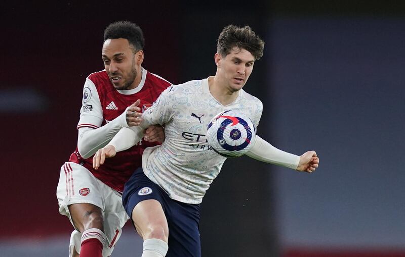 City defender John Stones under pressure from Arsenal attacker Pierre-Emerick Aubameyang. EPA