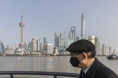 A pedestrian wearing a protective mask walks on the Bund waterfront in Shanghai, China. More than 20,000 coronavirus infection cases have now been recorded globally and the death toll in China has risen above 400 people. Bloomberg