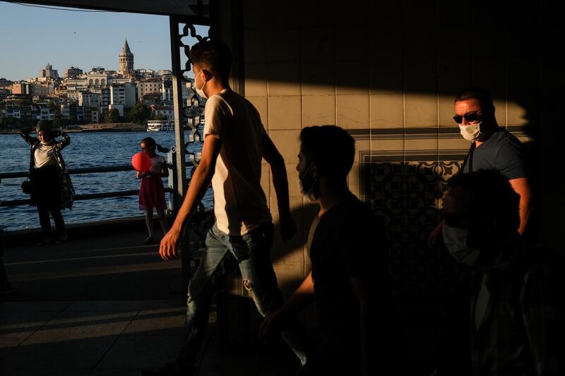 People wearing face masks as they walk underpass near Eminonu Square, in Istanbul.  EPA