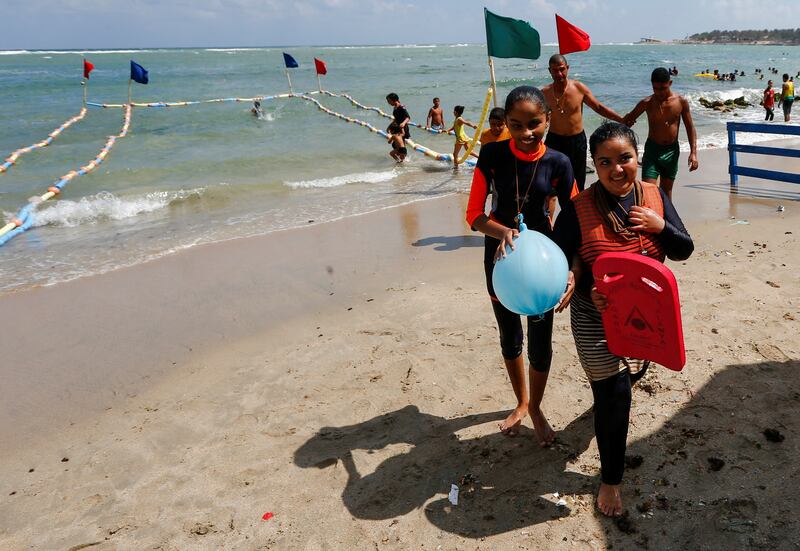 Farah walks with her sister at Al Mandara beach on the Mediterranean coast in Alexandria. Reuters