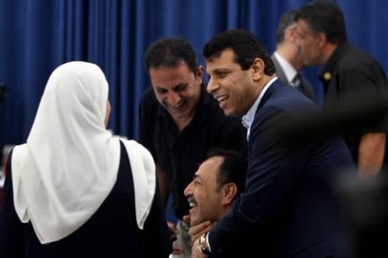 Gaza-born Fatah leader Mohammed Dahlan (R) greets fellow party members during a Fatah Central Committee meeting with Palestinian president Mahmud Abbas in the West Bank city of Ramallah on 16 August 2009. Rival Palestinian strongmen Mohammed Dahlan and Jibril Rajub are among the most prominent members of Fatah's top governing body elected at a landmark 10-day-long party congress.    AFP PHOTO /ABBAS MOMANI