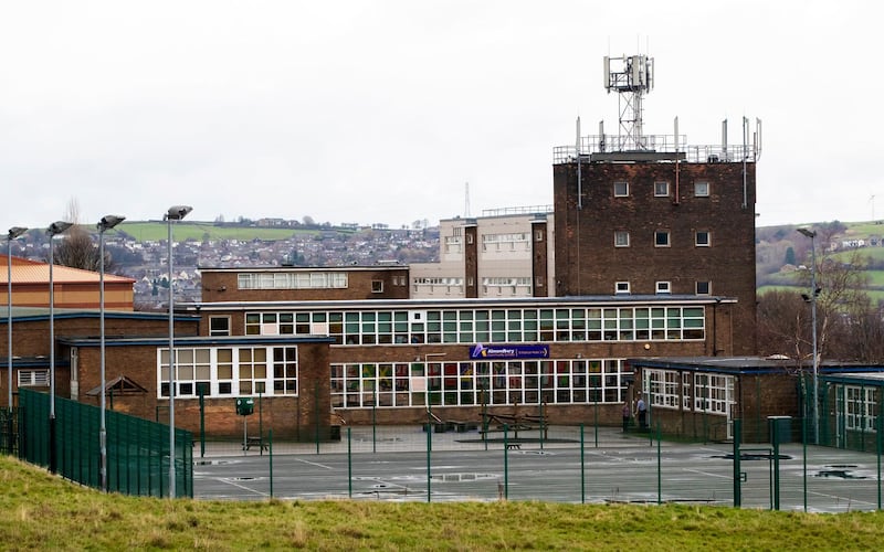 This Wednesday, Nov. 28, 2018 photo shows Almondbury Community School in Huddersfield where a 16-year-old boy is to be charged with assault over an attack on a 15-year-old Syrian refugee. A Syrian refugee who was the victim of a lunchtime bullying incident widely shared on social media says he no longer feels safe at his U.K. school. (Danny Lawson/PA via AP)