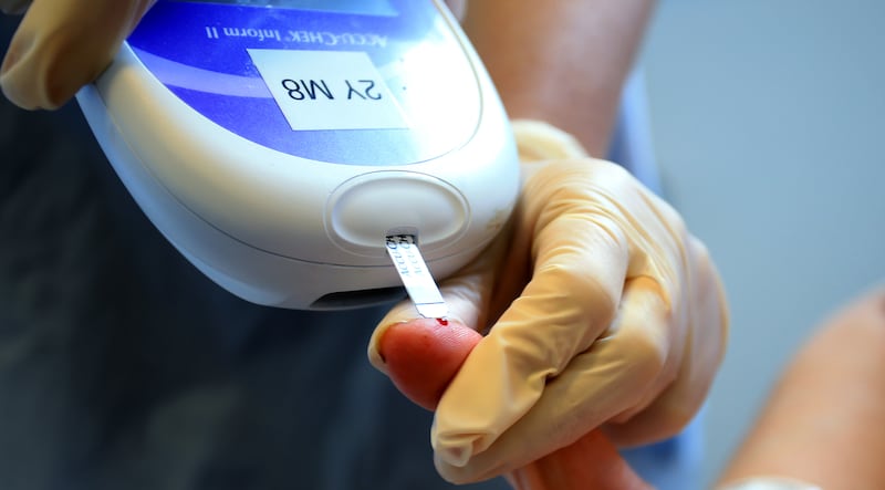 A nurse gives a patient a blood sugar test. In the new study, those who had Covid-19 showed a 28 per cent increased risk of being diagnosed with type 2 diabetes. PA