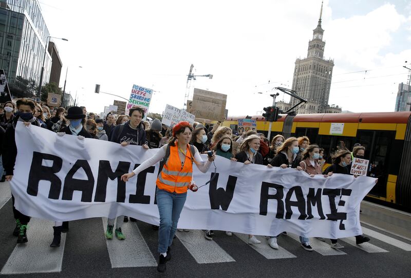 Young environmental activists take part in a demonstration in Warsaw, Poland. The banner reads 'Hand in hand'. Reuters