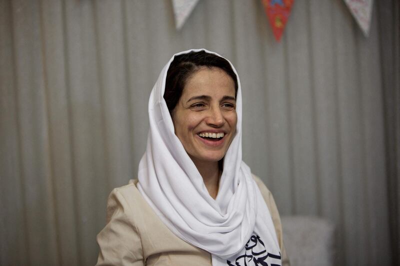 (FILES) In this file photo taken on September 18, 2013 Iranian lawyer Nasrin Sotoudeh smiles at her home in Tehran, after being freed following three years in prison. French Foreign Minister Jean-Yves Le Drian said on February 24, 2021 he was "very concerned" about the fate of Iranian lawyer Nasrin Sotoudeh, who is once again imprisoned in Iran, and called for the release of Franco-Iranian researcher Fariba Adelkhah before the UN Human Rights Council. / AFP / Behrouz MEHRI
