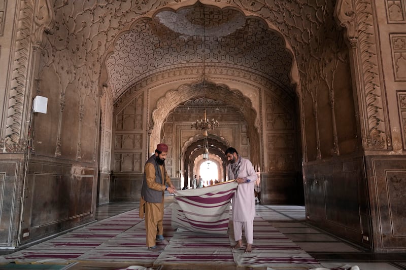 Workers clean the carpet in the Badshahi Mosque in preparation for Ramadan, Lahore, Pakistan. AP