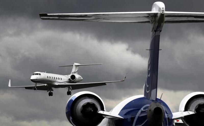A business jet comes in to land behind a Bombardier CRJ900 plane at Farnborough in southern England. Luke MacGregor / Reuters