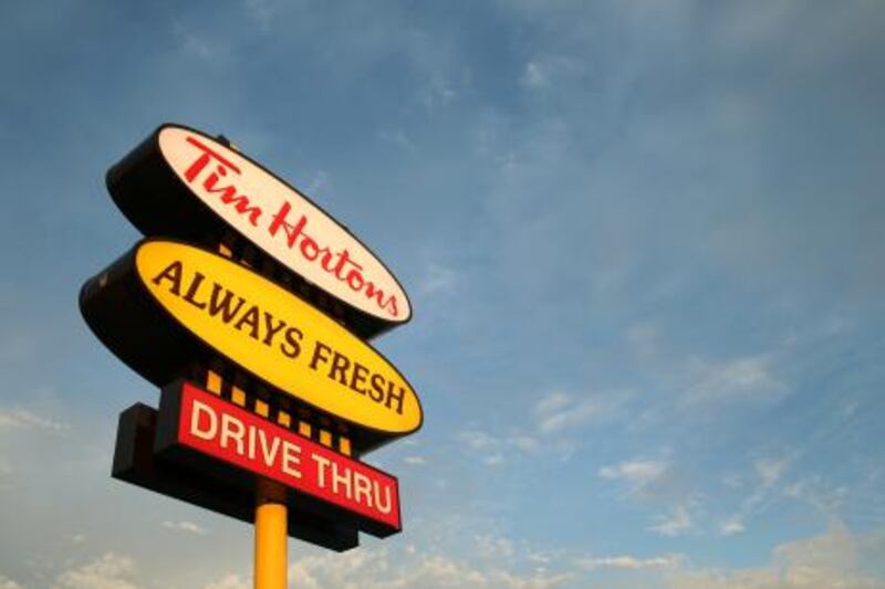 The sun sets on a Tim Hortons coffee shop sign in Cookstown, Ontario. The first Tim Hortons location was opened in 1964 in Hamilton, Ont. and has since grown to Canada's largest coffee shop chain with over 2,200 locations. The Canadian Press/Steve White (Canadian Press via AP Images)