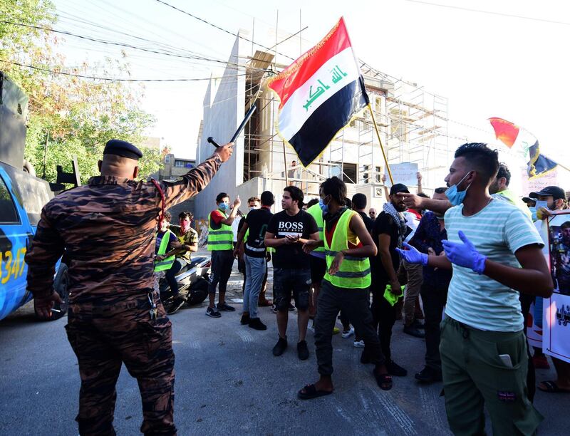 Iraqi security forces stand guard as Iraqis protest in front of the Turkish embassy in Baghdad, Iraq.  EPA