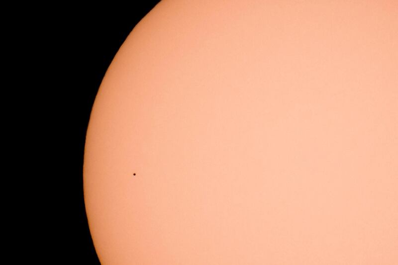 The planet Mercury looks like a tiny dot as it transits across the face of the Sun as seen from Kekesteto, Hungary' highest mountain peak.  EPA