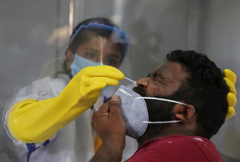 A health worker takes a nasal swab sample to test for Covid-19 in Hyderabad, India. India has the third-highest coronavirus caseload after the United States and Brazil, and the fourth-highest death toll in the world. AP