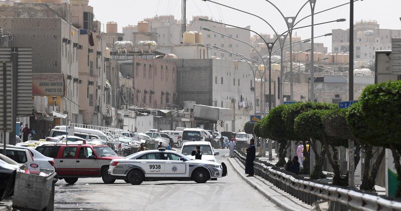 A Kuwaiti police vehicle is seen at the entrance of the Jeleeb Al Shuyoukh street, south of Kuwait City during a lockdown. EPA