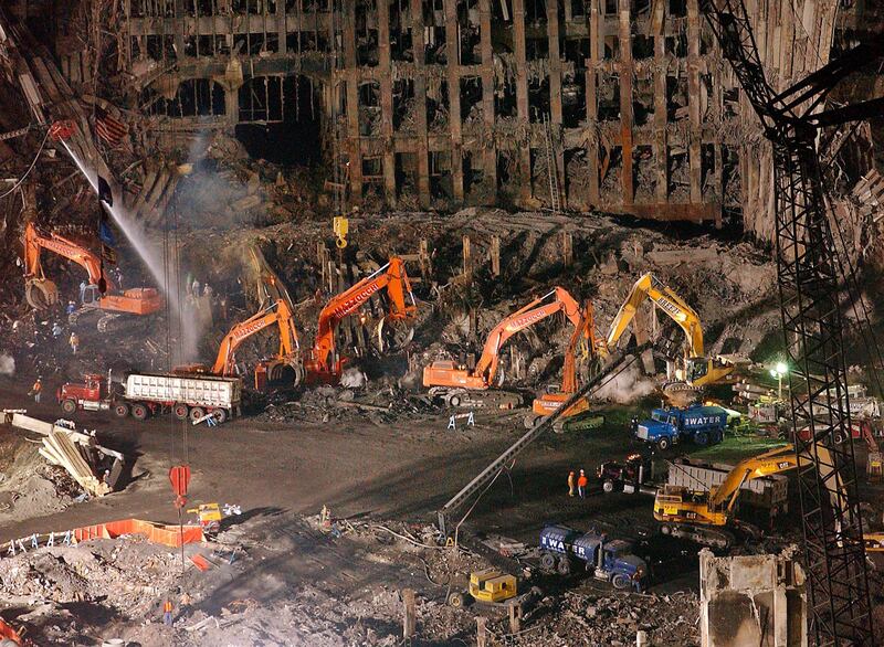 FILE - In this Nov. 7, 2001 file photo, workers and heavy machinery continue the cleanup and recovery effort in front of the remaining facade of 1 World Trade Center at ground zero in New York.The remains of a man killed at the World Trade Center on 9/11 have been identified for the first time nearly 16 years after the terror attacks, the New York City medical examiners' office announced Monday Aug.7, 2017. Medical examiners use DNA testing and other means to try to match bone fragments to the 2,753 people killed by the hijackers who crashed airplanes into the trade center's twin towers on Sept. 11, 2001. Remains of 1,641 victims have been identified so far.(AP Photo/Stephen Chernin, File)