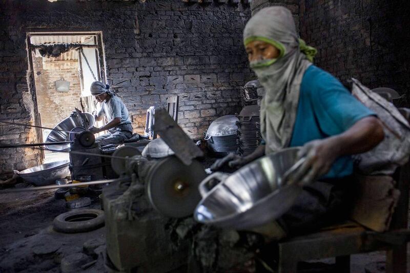 A workshop labourer polishes a pan in Yogyakarta, Indonesia on May 1. Up to 100,000 Indonesian workers took to the streets to celebrate the country's first ever Labour Day. Ulet Ifansasti / Getty Images