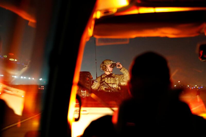 A US soldier looks through night vision goggles while riding with the Presidential Motorcade. Reuters