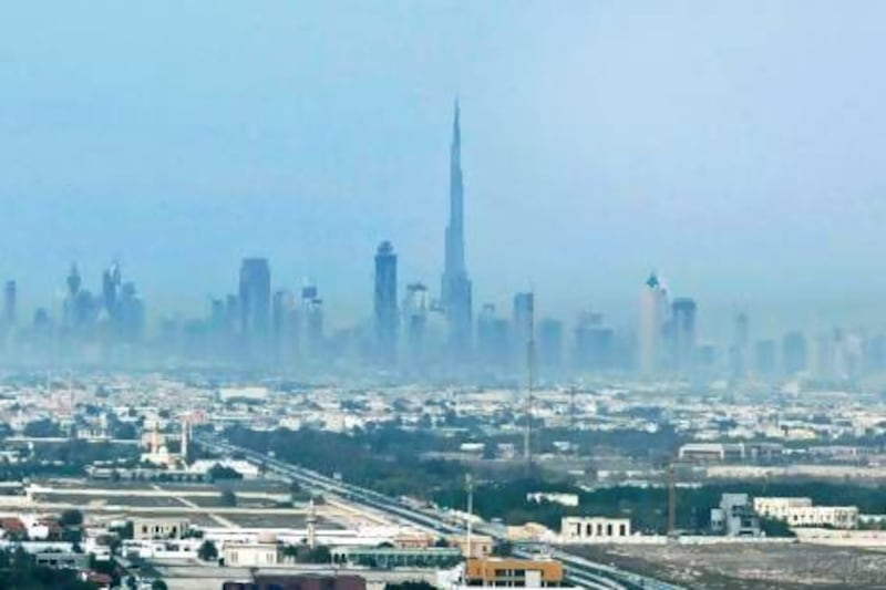 Scientists are to study what effect car exhaust fumes have on smog such as that shrouding the Dubai skyline last year. Jeff Topping / The National