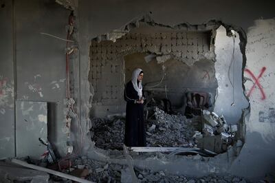 The mother of Palestinian prisoner Kamal Jouri in the ruins of the house belonging to the family. AP