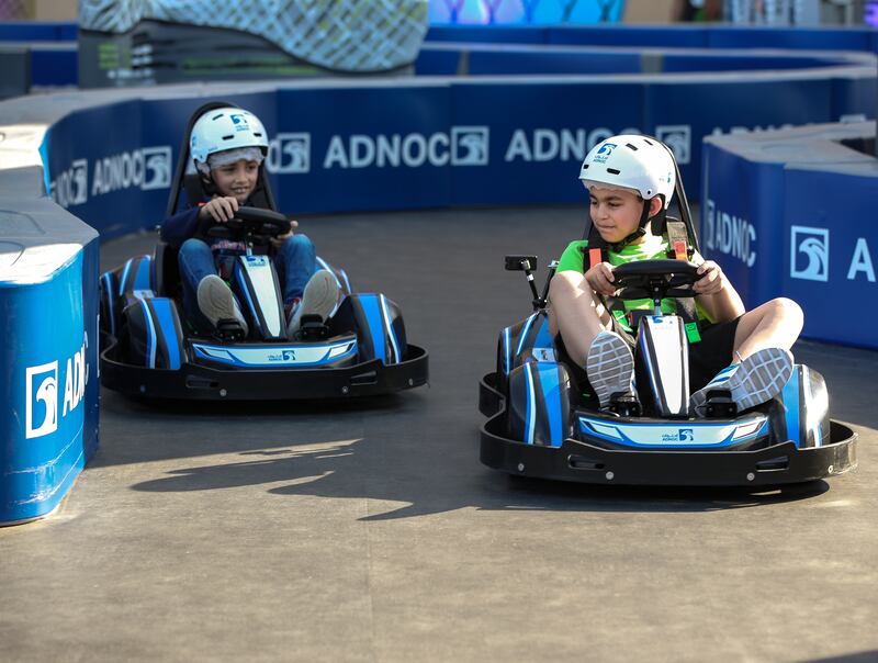 Children driving karts at the F1 fan zone on Friday