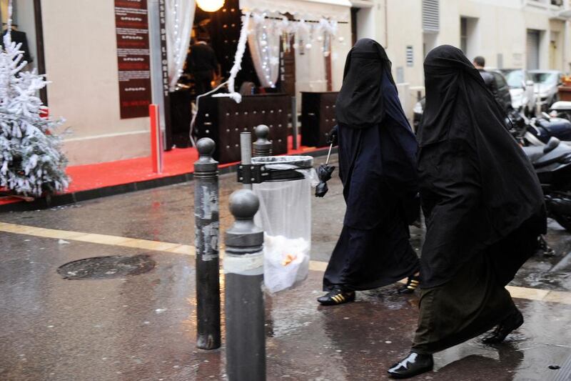 Two veiled Muslim women in a street in Marseille, southern France, on December 24, 2009. A survey by The New York Times claims Muslim women in France are victimised for wearing Muslim clothing. Michel Gangne / AFP 