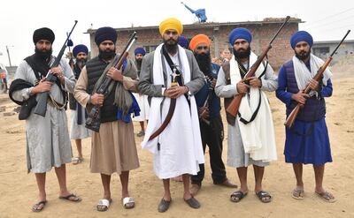 Amritpal Singh, in yellow turban, with supporters in a village near Amritsar in January. AP