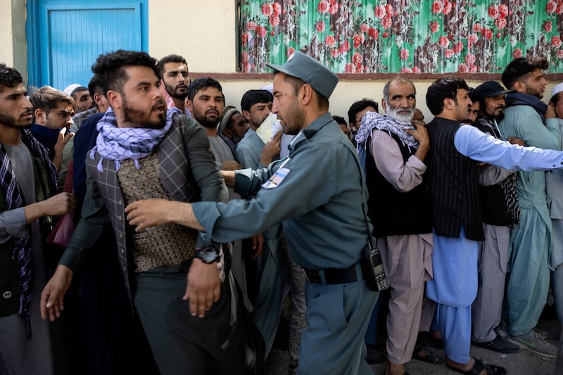 Afghans have been waiting for hours in long queues outside the passport office in Kabul, with many people desperate to leave the country.