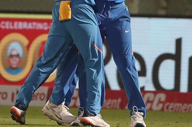 India's Kuldeep Yadav (C) celebrates with teammates a hat-trick of dismissals during the second one day international (ODI) cricket match between India and the West Indies in Visakhapatnam on December 18, 2019. - ----IMAGE RESTRICTED TO EDITORIAL USE - STRICTLY NO COMMERCIAL USE----- / AFP / STR / ----IMAGE RESTRICTED TO EDITORIAL USE - STRICTLY NO COMMERCIAL USE-----