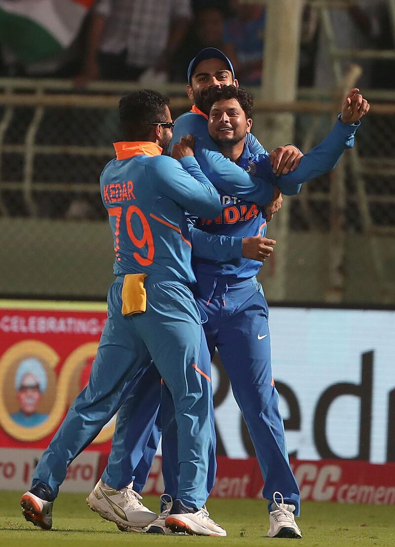 India's Kuldeep Yadav (C) celebrates with teammates a hat-trick of dismissals during the second one day international (ODI) cricket match between India and the West Indies in Visakhapatnam on December 18, 2019.  - ----IMAGE RESTRICTED TO EDITORIAL USE - STRICTLY NO COMMERCIAL USE-----
 / AFP / STR / ----IMAGE RESTRICTED TO EDITORIAL USE - STRICTLY NO COMMERCIAL USE-----
