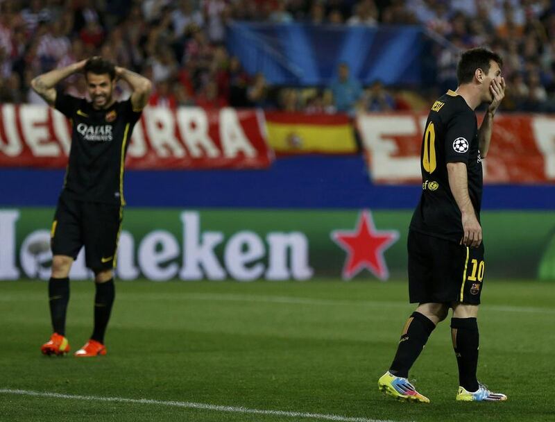 FC Barcelona players Lionel Messi and Cesc Fabregas react after missing an opportunity to score during their Champions League loss to Atletico Madrid. Sergio Perez / Reuters / April 9, 2014