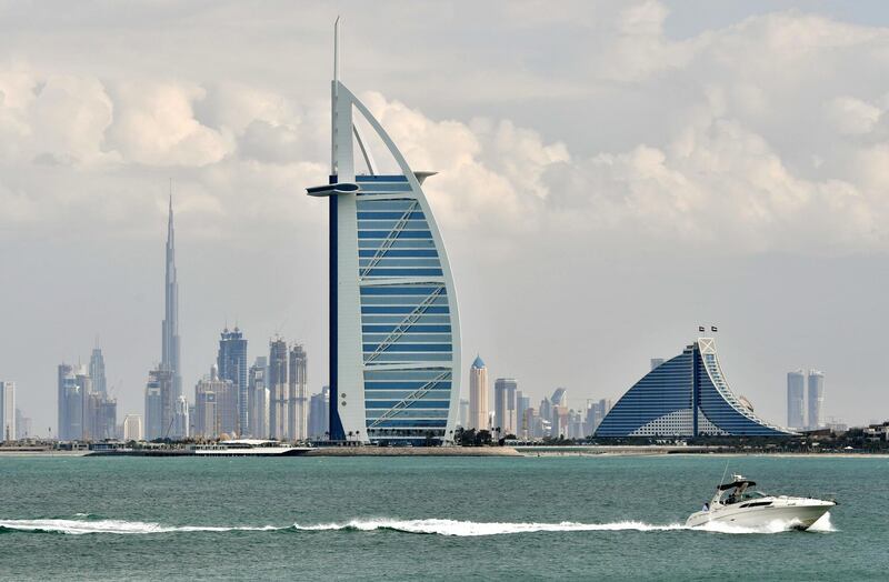 A picture taken on January 8, 2018 shows the skyline of Dubai with the Burj al-Arab in the foreground and Burj Khalifa (L) in the background. (Photo by GIUSEPPE CACACE / AFP)