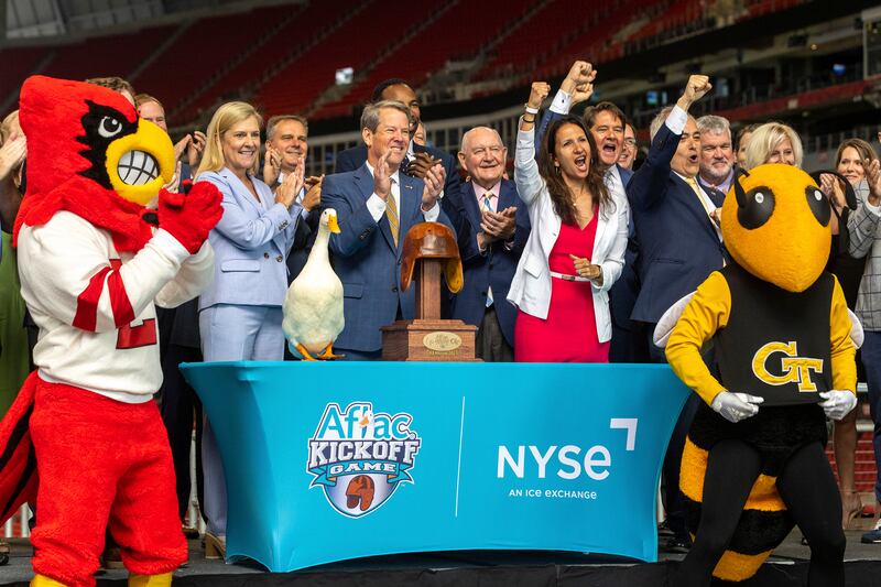 Georgia Governor Brian Kemp, flanked by the Aflac Duck and mascots from Louisville and Georgia Tech, during the remote ringing of the New York Stock Exchange's opening bell from Mercedes-Benz Stadium in Atlanta ahead of the Aflac Kickoff Game. It was the first time the NYSE opening bell was rung from the south-eastern US state. AP