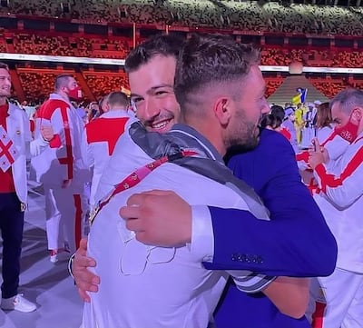 Alaa Maso and his brother Mohamed embrace at the Tokyo Olympics opening ceremony. The photo went viral on social media. @M_Alneser / Twitter