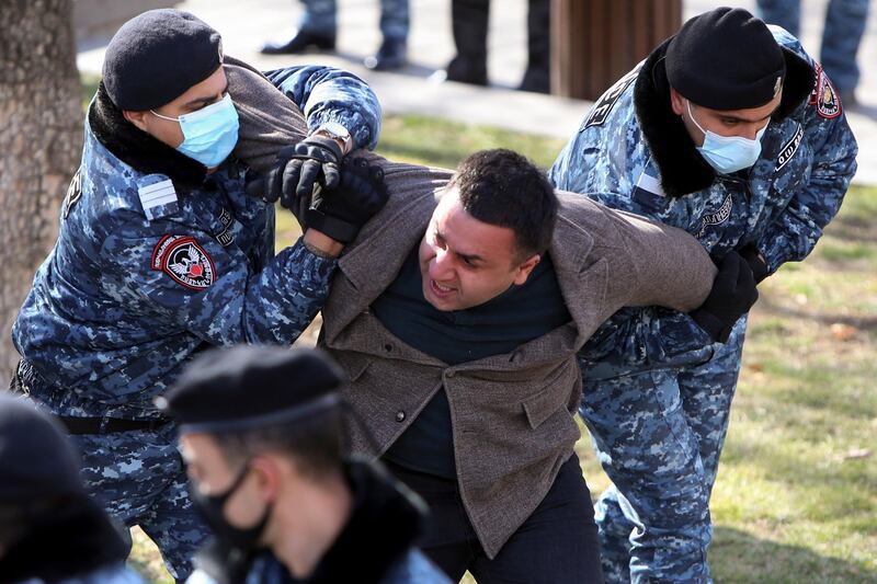 Police detain an opposition demonstrator. AP