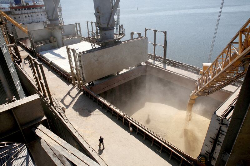 A dockyard worker watches as barley is mechanically poured into a 40,000-tonne ship at a Ukrainian agricultural exporter's terminal in the city of Nikolaev. Reuters