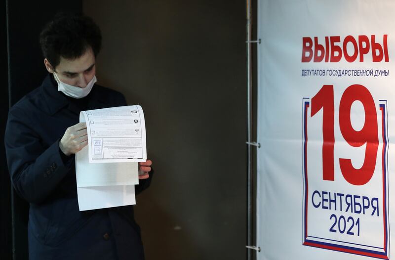 A man reads his ballots at a polling station inside the Gulag History Museum in Moscow. Reuters