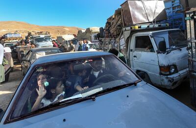 epa06906535 Syrian refugees sit inside their cars waiting to be evacuated from their refugee camps in the village of Arsal, east of Lebanon, 23 July 2018, to return home to their villages in al-Qalamoun area in the western Damascus countryside. According to media reports, Lebanon hosts 1,011,366 Syrian refugees registered with UNHCR, Including 80 thousand refugees living in seven camps in the city of Arsal. 850 person who have permission from the Syrian authority left to return home on 23 July 2018, where tousends of Syrian refugees families registers their names and wait the syrian permission.  EPA/NABIL MOUNZER