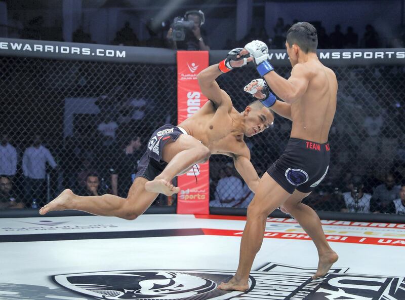 Abu Dhabi, United Arab Emirates, October 18, 2019.  UAE Warriors Fighting Championship at the Mubadala Arena.  (L-R)  Rolando Dy of the Philippines slips on the mat in his featherweight title bout against Koran Lee Do-gyeom from South Korea.  Dy later on lost his fetherweight title due to a swift KO by Lee Do-gyeom.
Victor Besa/The National
Section:  SP
Reporter:  Amith Passela