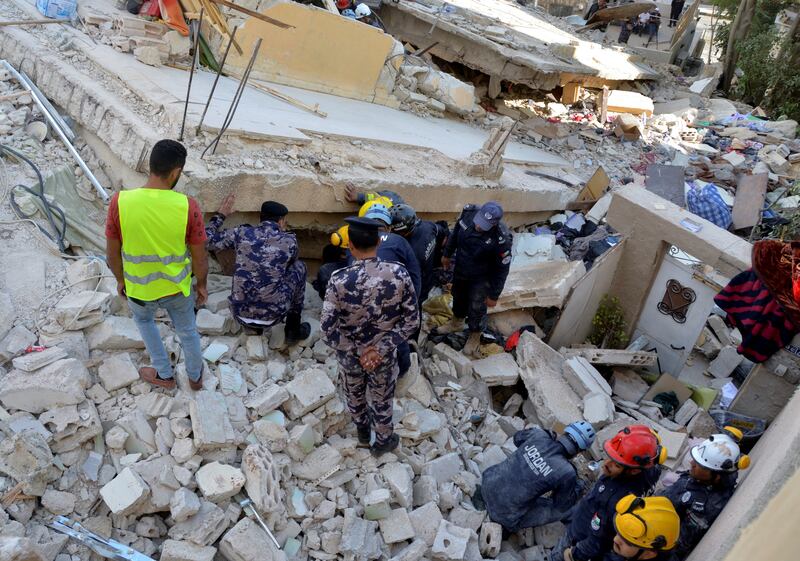 Rescuers search for survivors under the rubble a four-storey residential building that collapsed in Amman. Reuters