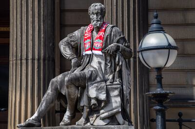 A statue is decorated with a Liverpool football scarf outside the Walker Art Gallery in Cultural Quarter. Darren Robinson for The National