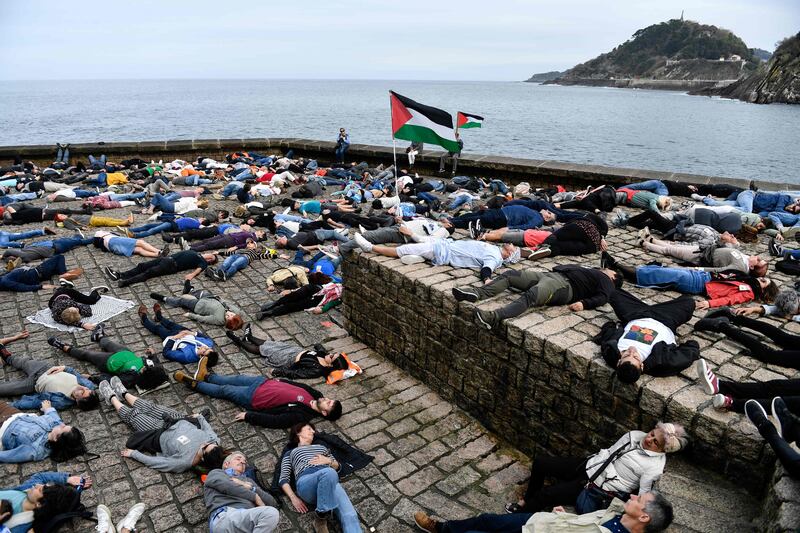 Demonstrators take part in a protest performance in support of Palestinians in Gaza, under the slogan 'Stop genocide', in the Spanish Basque city of San Sebastian. AFP