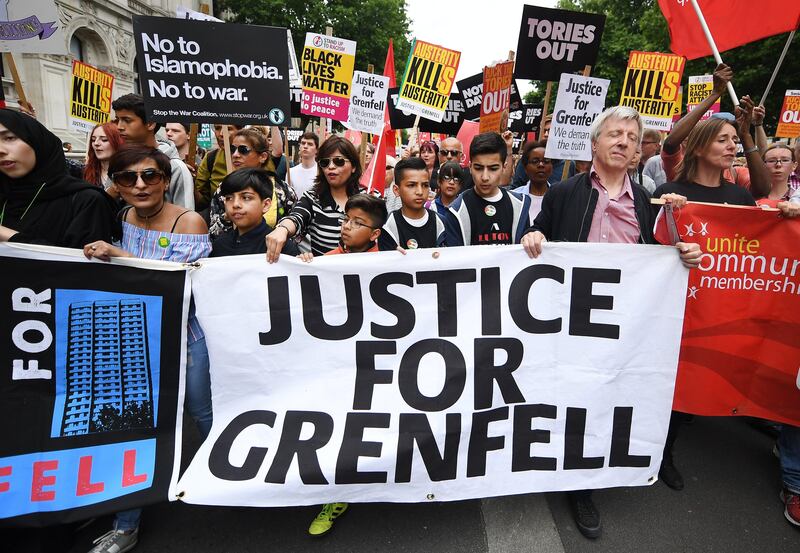 Demonstrators at anti-austerity protests in London hold a banner demanding justice for the victims and survivors of the Grenfell tower fire, which claimed at least 80 lives when a block of social housing caught fire on June 14