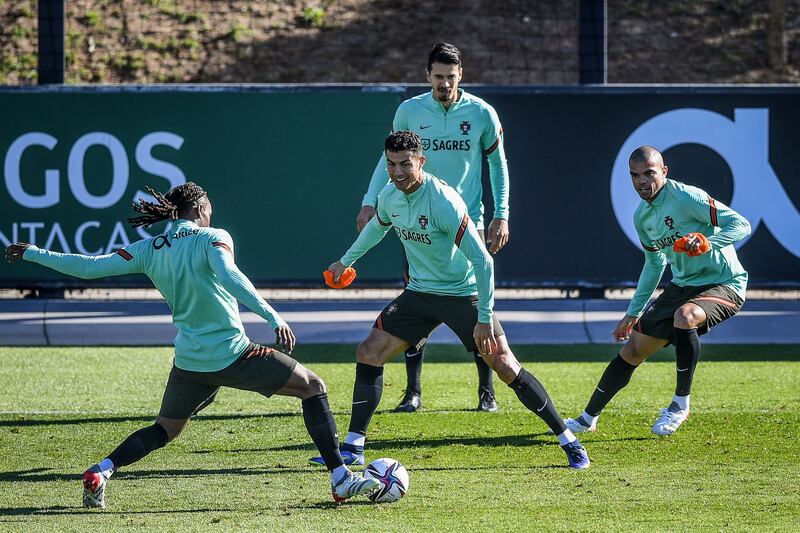 Portugal's forward Cristiano Ronaldo (C) and teammates attend a training session at the Cidade do Futebol training camp in Oeiras, outside Lisbon, on November 11, 2021, ahead of their FIFA World Cup Qatar 2022 qualifying football match against Ireland.  (Photo by PATRICIA DE MELO MOREIRA  /  AFP)